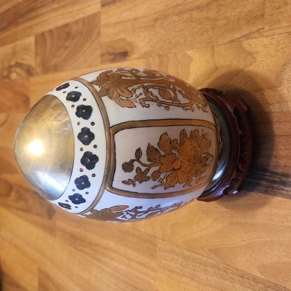 Gilded Gold Hand Painted Porcelain Egg With Lacquered Carved Wood Mirrored Base